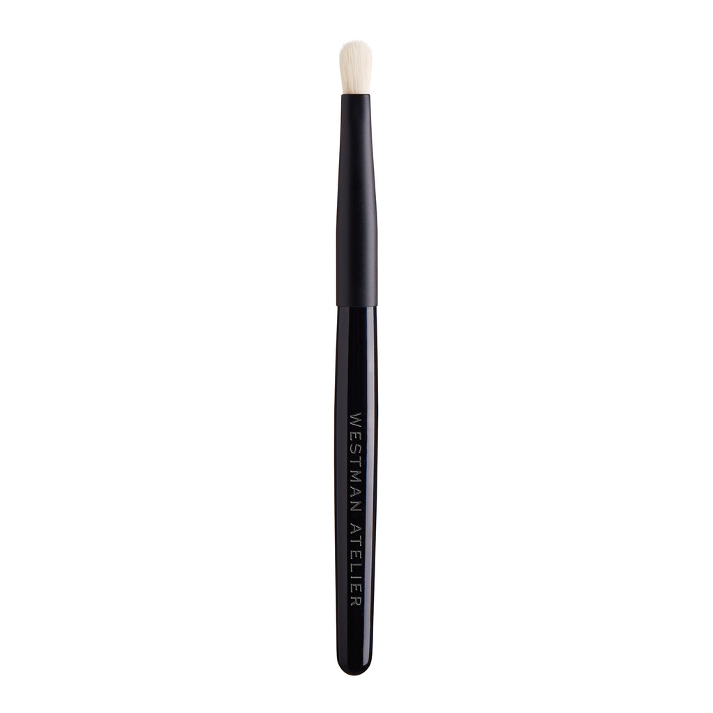 Eye shadow brush from westman atelier on a white background.