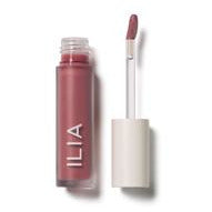 A tube of ilia brand lip gloss with an applicator wand removed from the tube, showing the product color.
