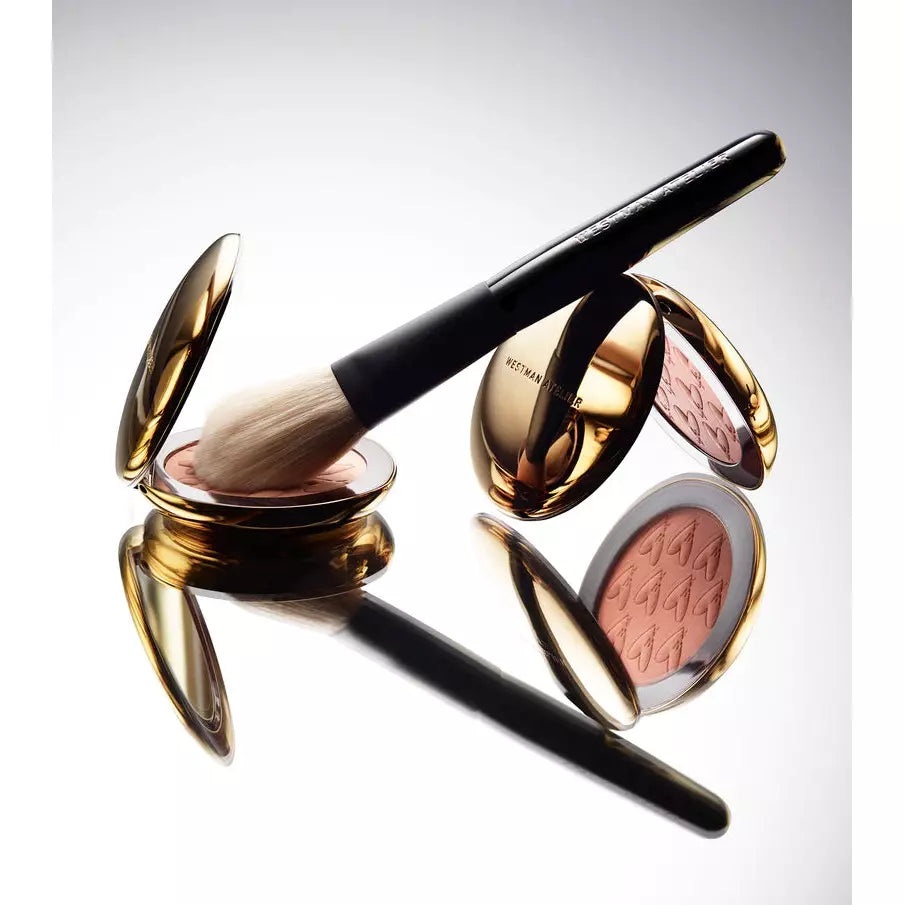 Elegant makeup brush and mirrored compacts floating against a neutral background.