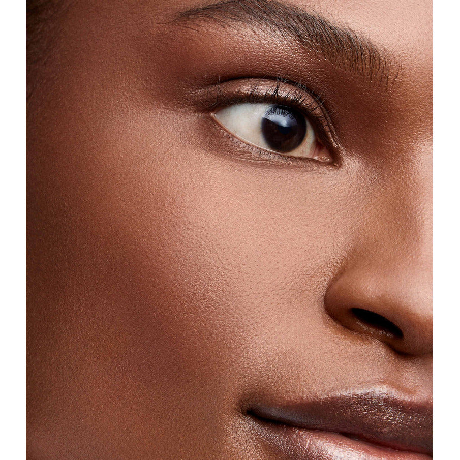 Close-up of a woman's eye and cheek, highlighting smooth skin and natural makeup.