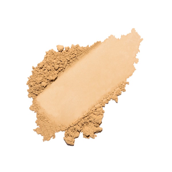 A swatch of loose powder foundation smeared on a white background.