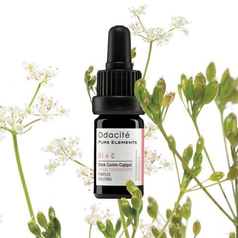 Bottle of odacite pure elements facial serum with natural botanical background.