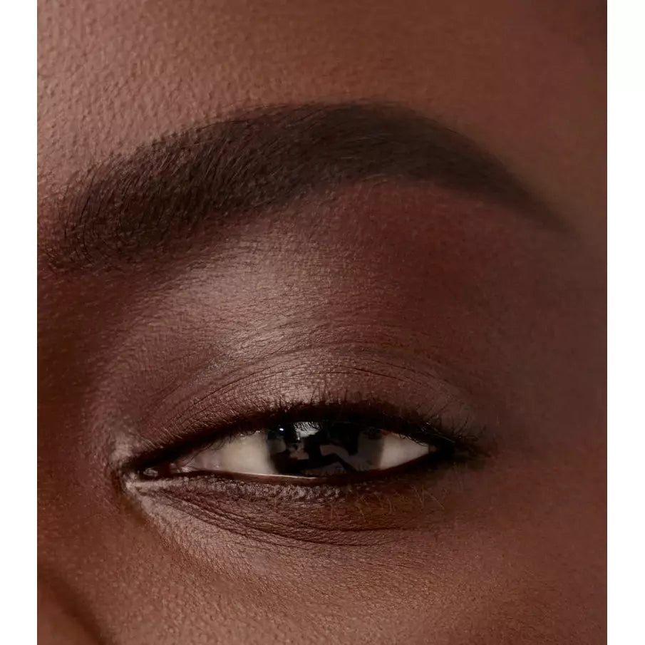 Close-up of a person's eye with brown eyeshadow.