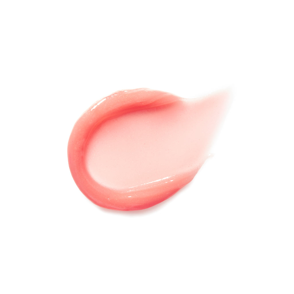 A swatch of pink lip gloss on a white background.