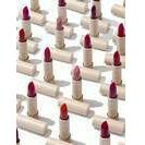 An array of identical red lipsticks with their caps removed.