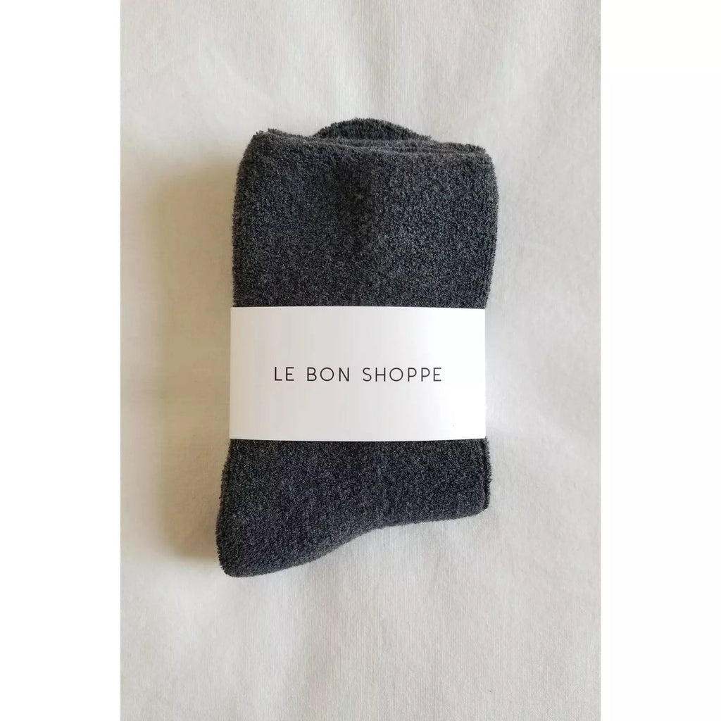 Folded dark gray socks with a label reading "le bon shoppe.