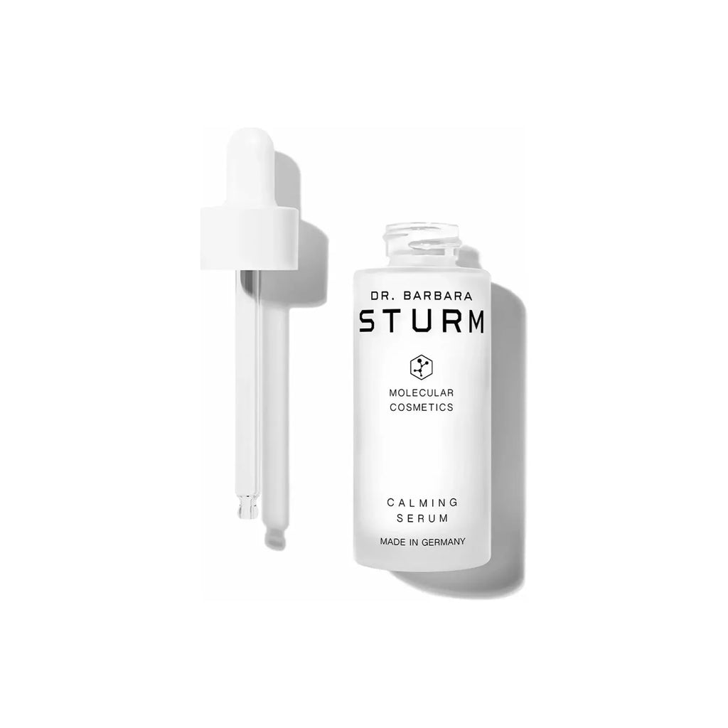 A bottle of dr. barbara sturm calming serum with a dropper applicator, isolated on a white background.