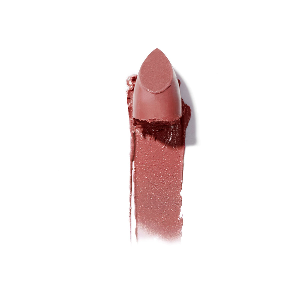 A smudged lipstick in a neutral shade against a white background.