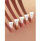 Five tubes of lipstick in varying shades aligned diagonally casting shadows on a beige background.