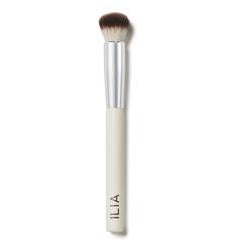 Makeup blending brush with a cream handle and silver ferrule.