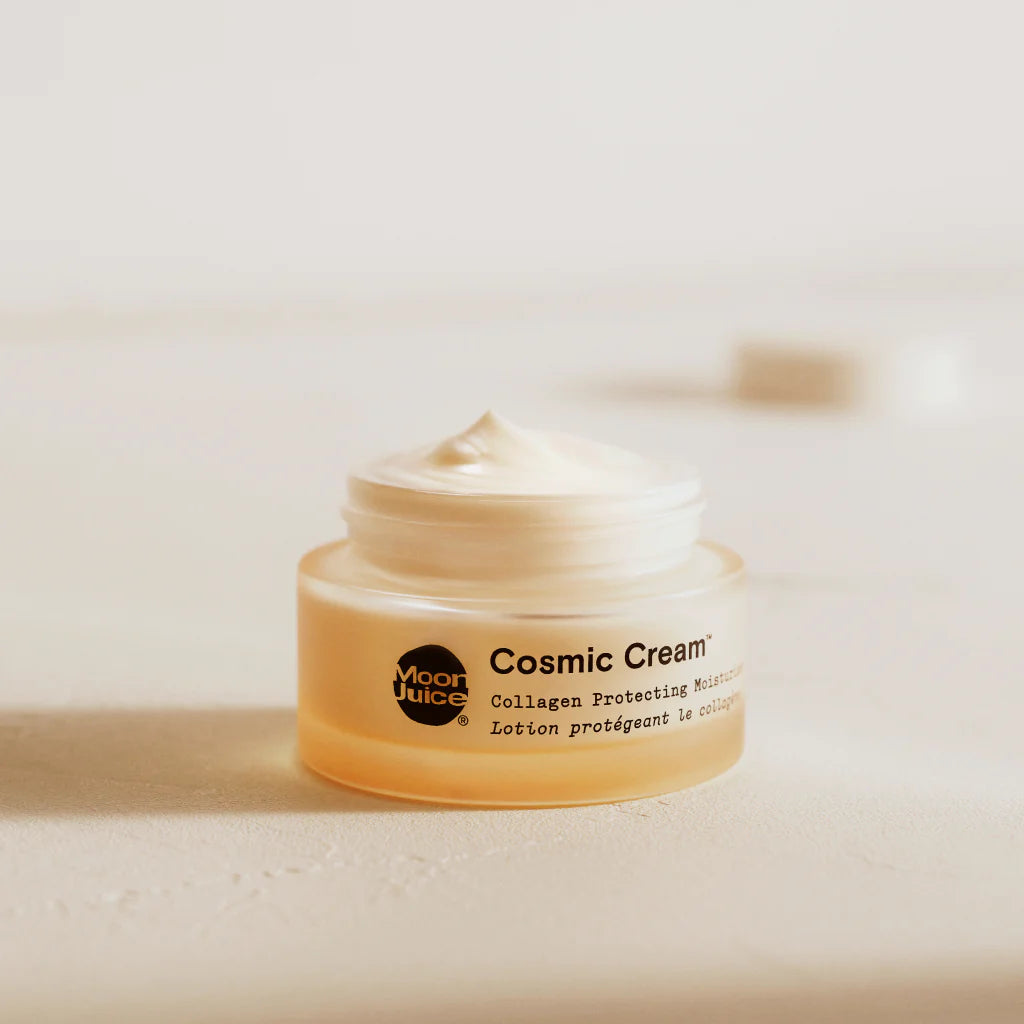 Open jar of cosmetic cream on a neutral background.