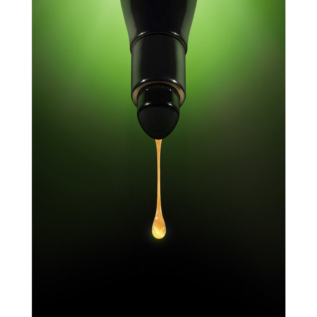 A single drop of liquid falling from a dropper against a green gradient background.