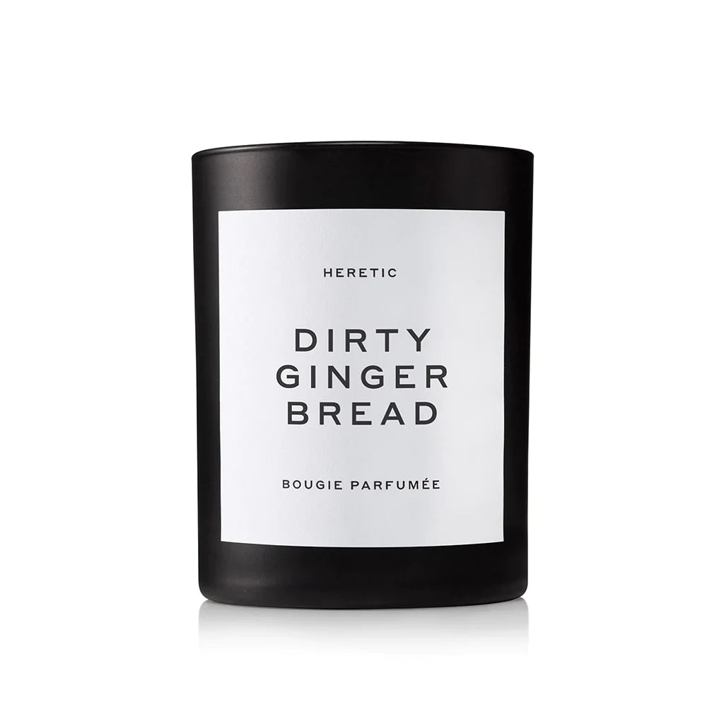 Black scented candle labeled "heretic dirty ginger bread bougie parfumee" on a white background.