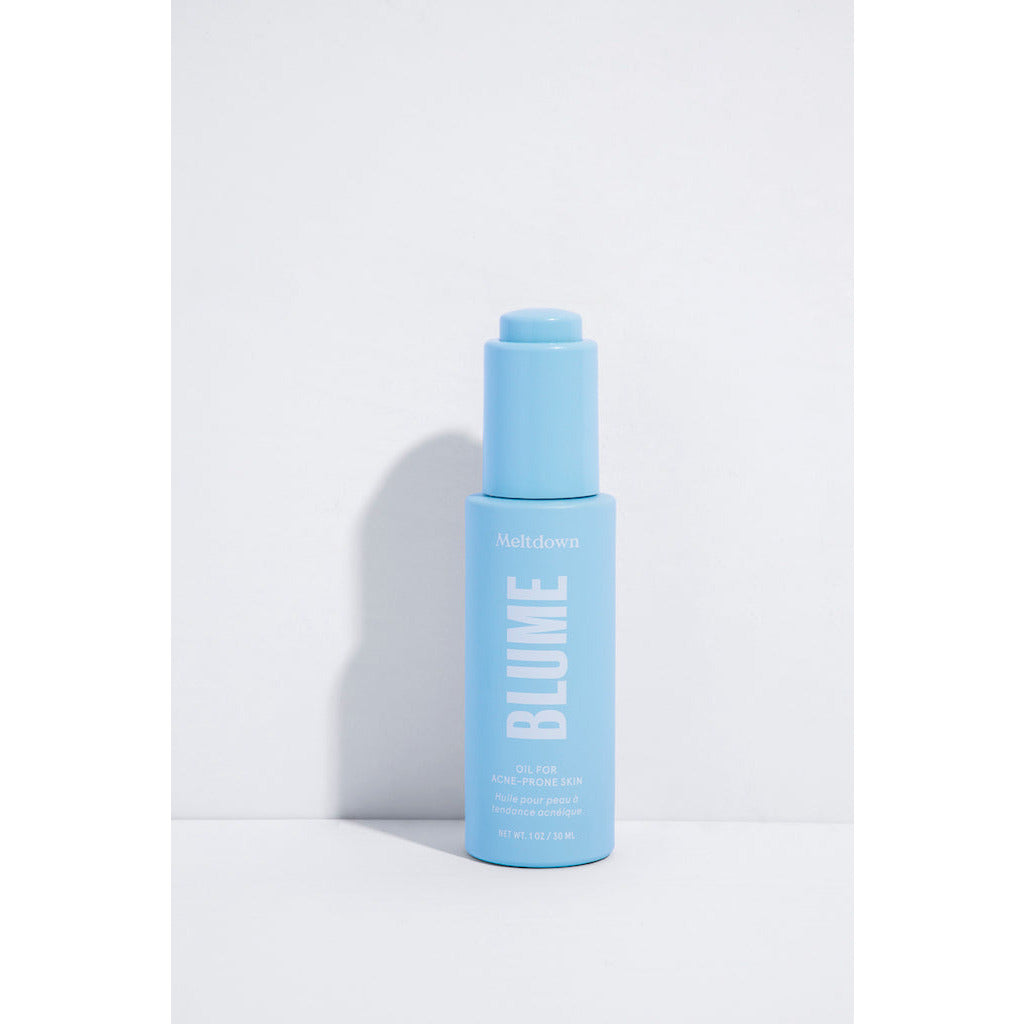 A blue bottle of blume meltdown acne treatment against a white background.