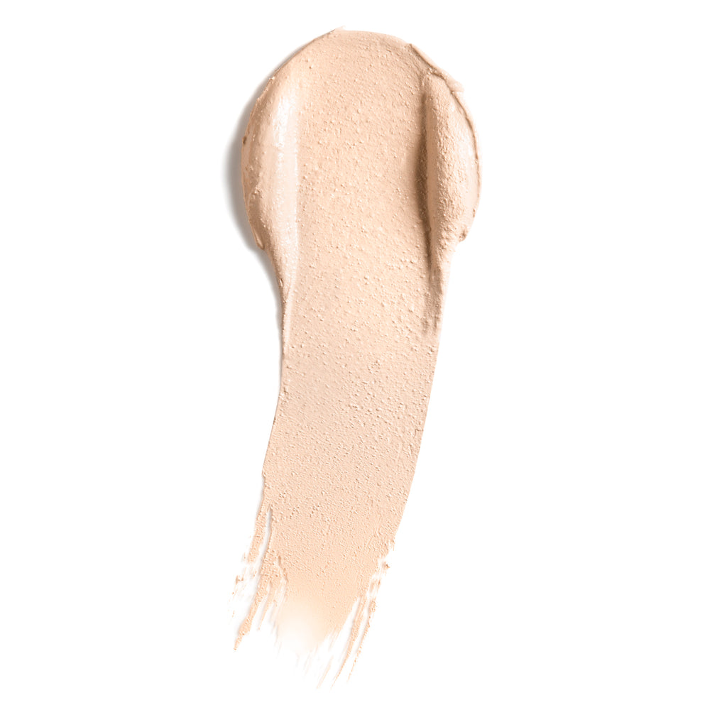 A smear of liquid foundation makeup isolated on a white background.