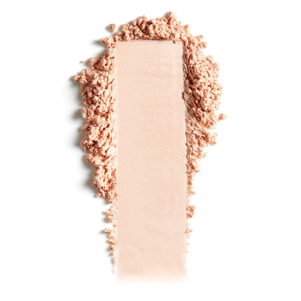 Swatch of crushed beige powder makeup on a white background.