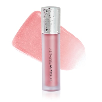 Lip gloss product from fitglow beauty with pink color and shiny cap, displayed against a white background with a blurred pink object in the background.