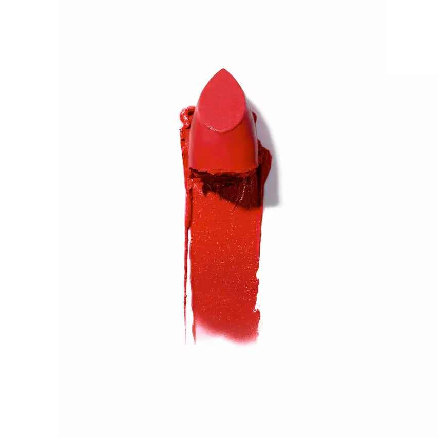 A broken red lipstick with the tip stained and smeared on a white background.