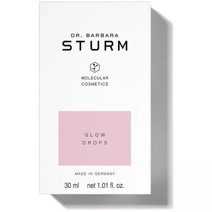 A product package labeled "dr. barbara sturm molecular cosmetics glow drops, 30 ml net 1.01 fl. oz.