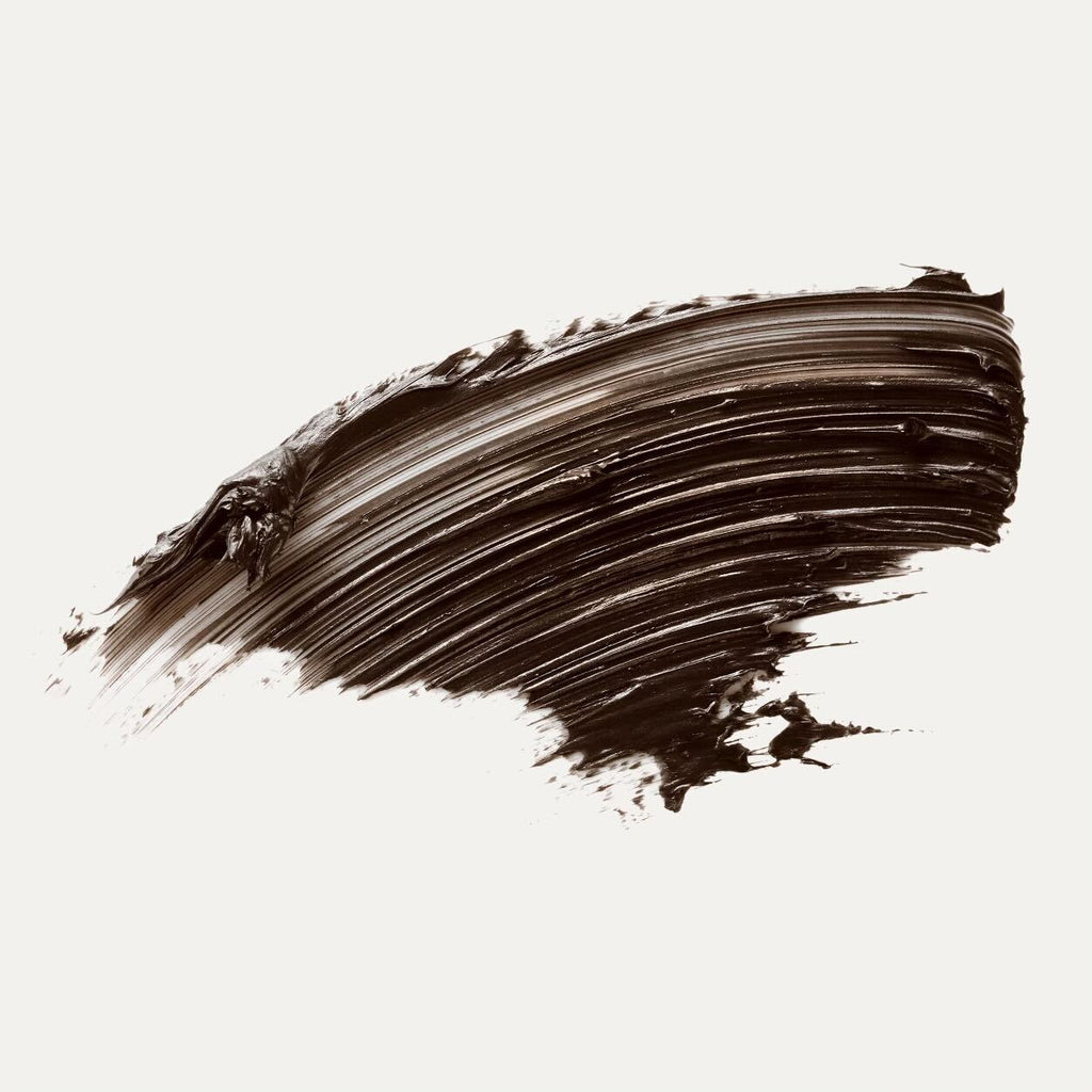 A broad brushstroke of black paint on a white background.