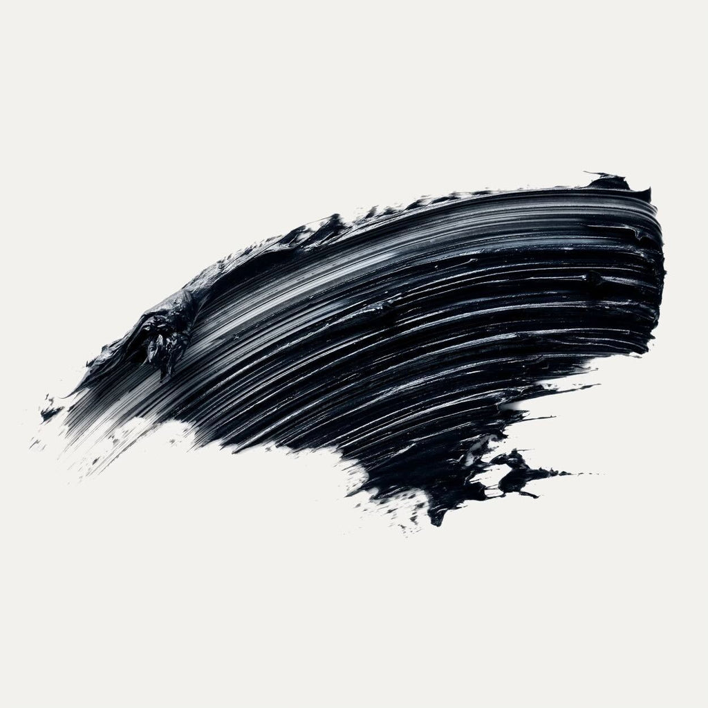 A single, bold brushstroke of black paint on a white background.