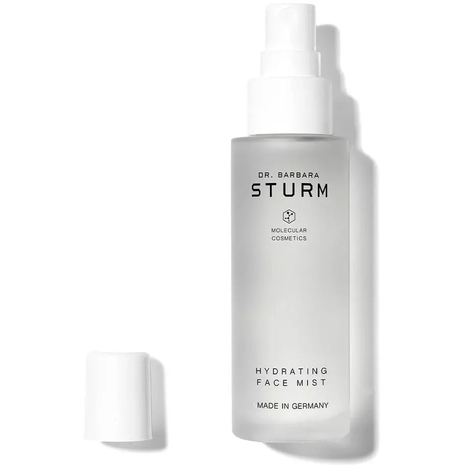 A bottle of dr. barbara sturm hydrating face mist with the cap off to the side.