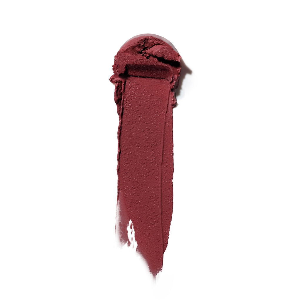 Smear of dark red lipstick on a white background.