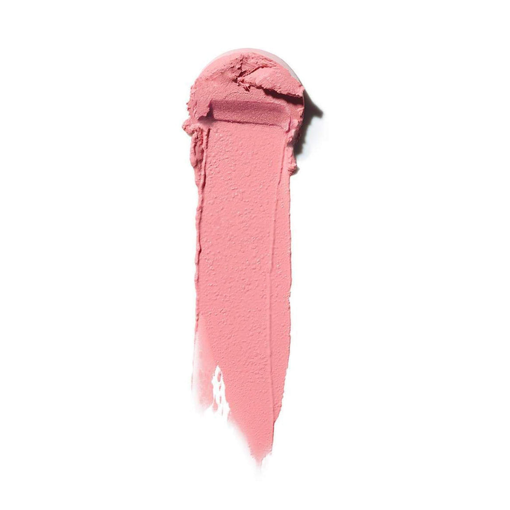 Swatch of pink lipstick smeared on a white background.