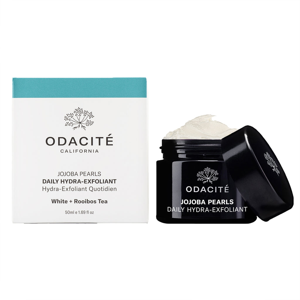Odacite skincare products: daily hydra-exfoliant with jojoba pearls and white tea displayed with packaging and open container.