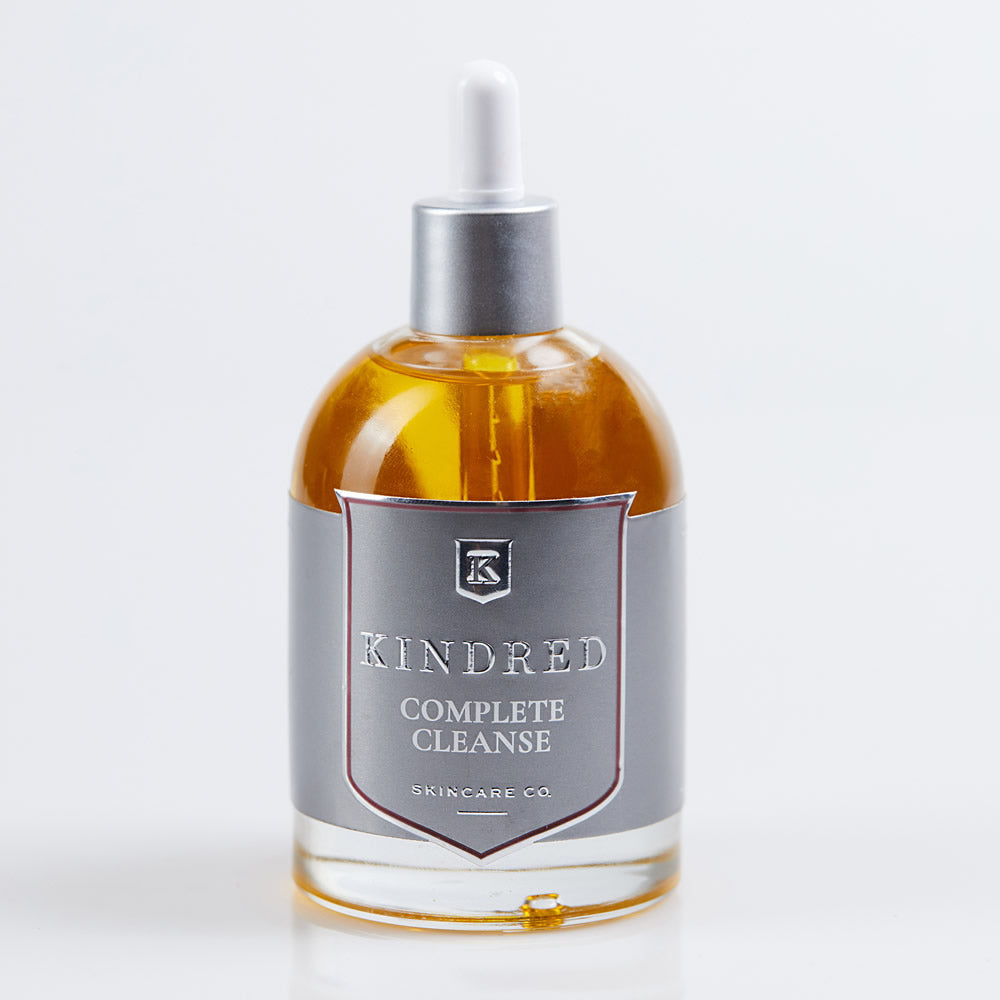 Amber glass skincare bottle with dropper and label on a white background.