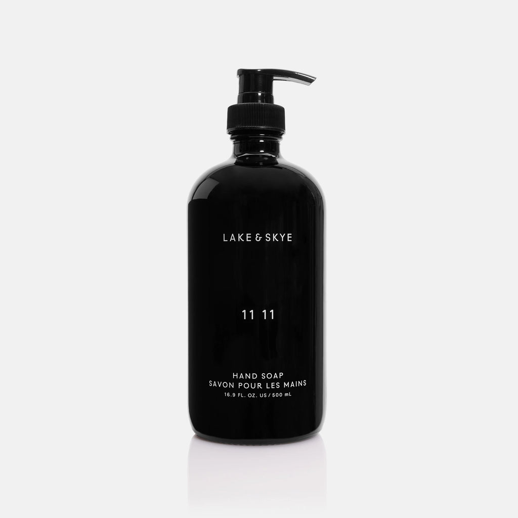 Black dispenser bottle of lake & skye 11 11 hand soap on a white background.