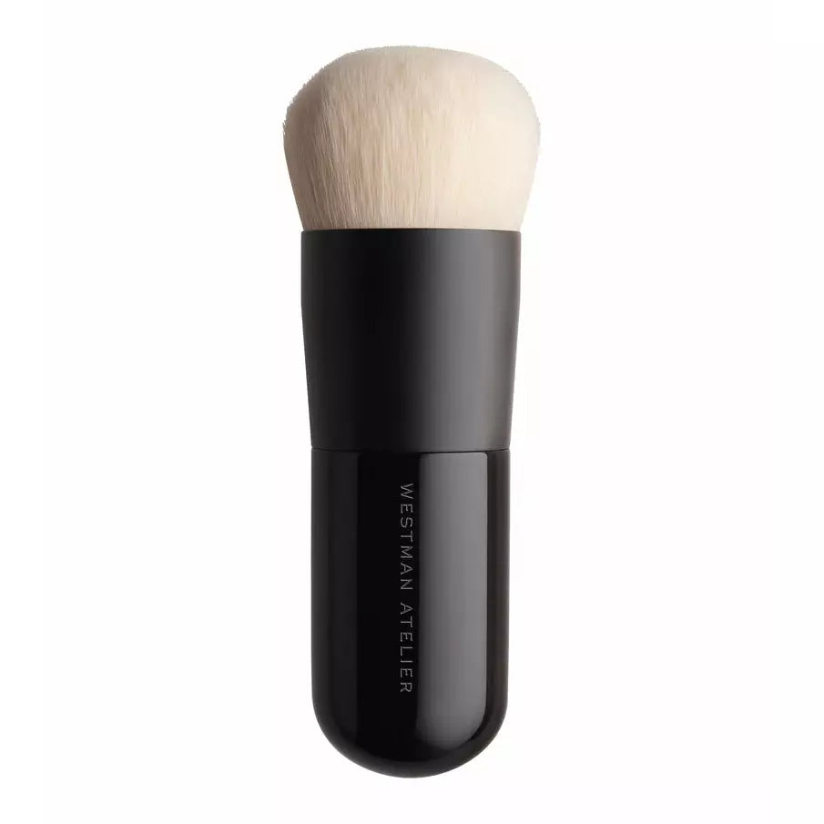 A large, fluffy makeup brush with a black handle.