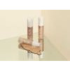 Miniature wooden chair with candles on a reflective surface.