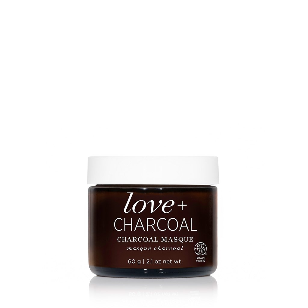 A jar of love + charcoal masque against a white background.
