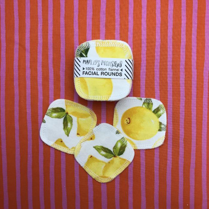 Reusable cotton flannel facial rounds with lemon patterns on a striped background.