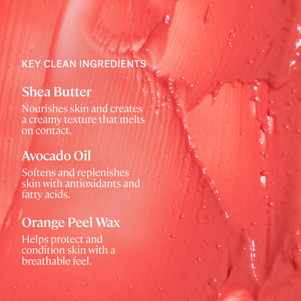 A smooth, creamy pink substance with a list of key ingredients that include shea butter, avocado oil, and orange peel wax, implying a skincare or cosmetic product.