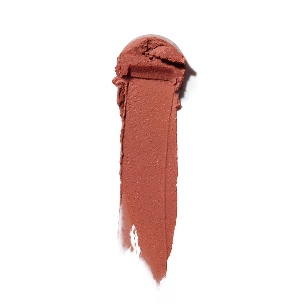 A single stroke of brown lipstick swatched on a white background.