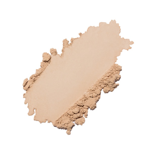 Smudge of beige powder foundation on a white background.