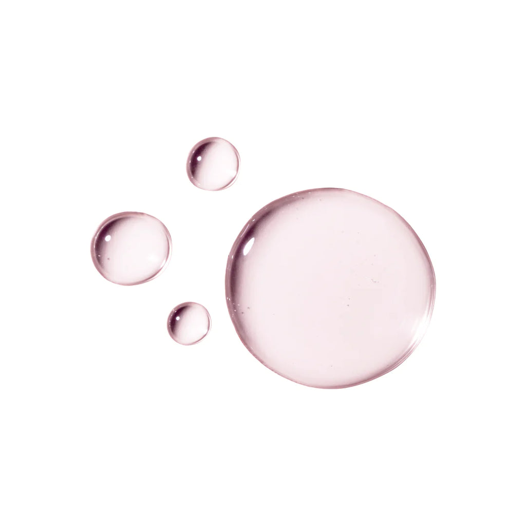 Four different-sized transparent pink droplets isolated on a white background.