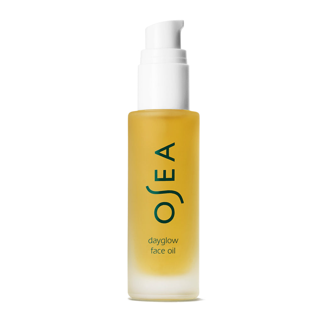 Clear bottle of osea dayglow face oil with pump dispenser against a white background.