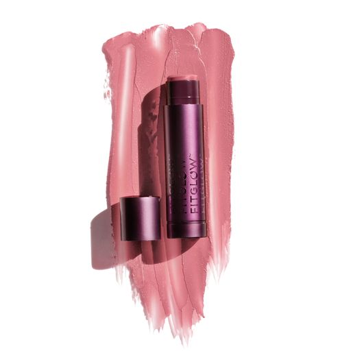A tube of lipstick with its cap off, lying on a textured smear of its pink shade.