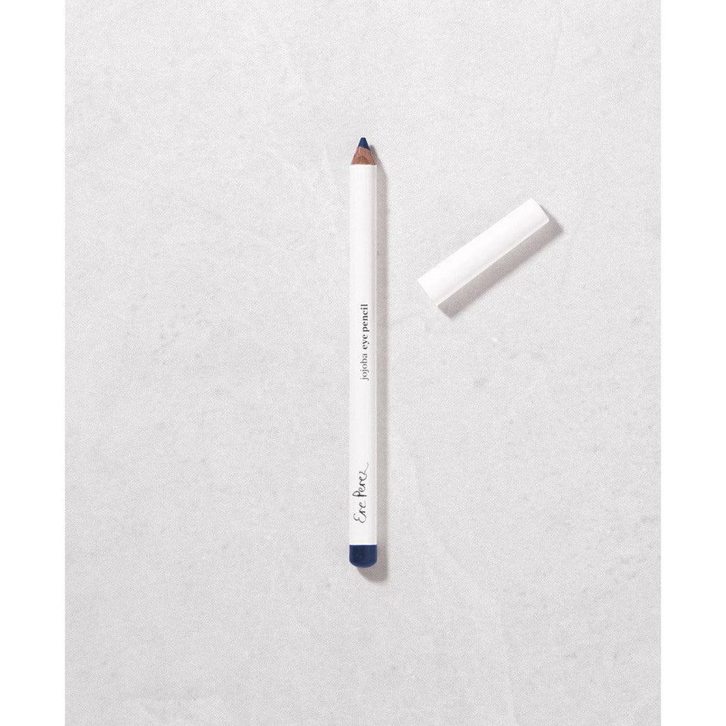 White pencil with cap off lying on a textured surface.