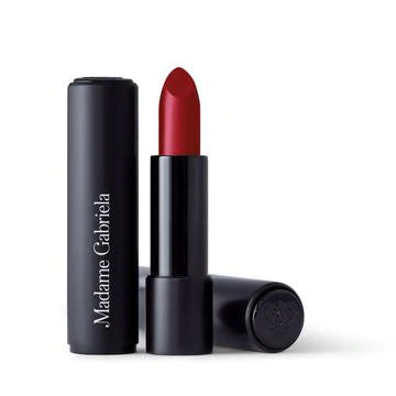 A single tube of red lipstick with the cap placed beside it, isolated on a white background.