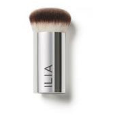 A silver and black makeup brush with "ilia" written on the handle.