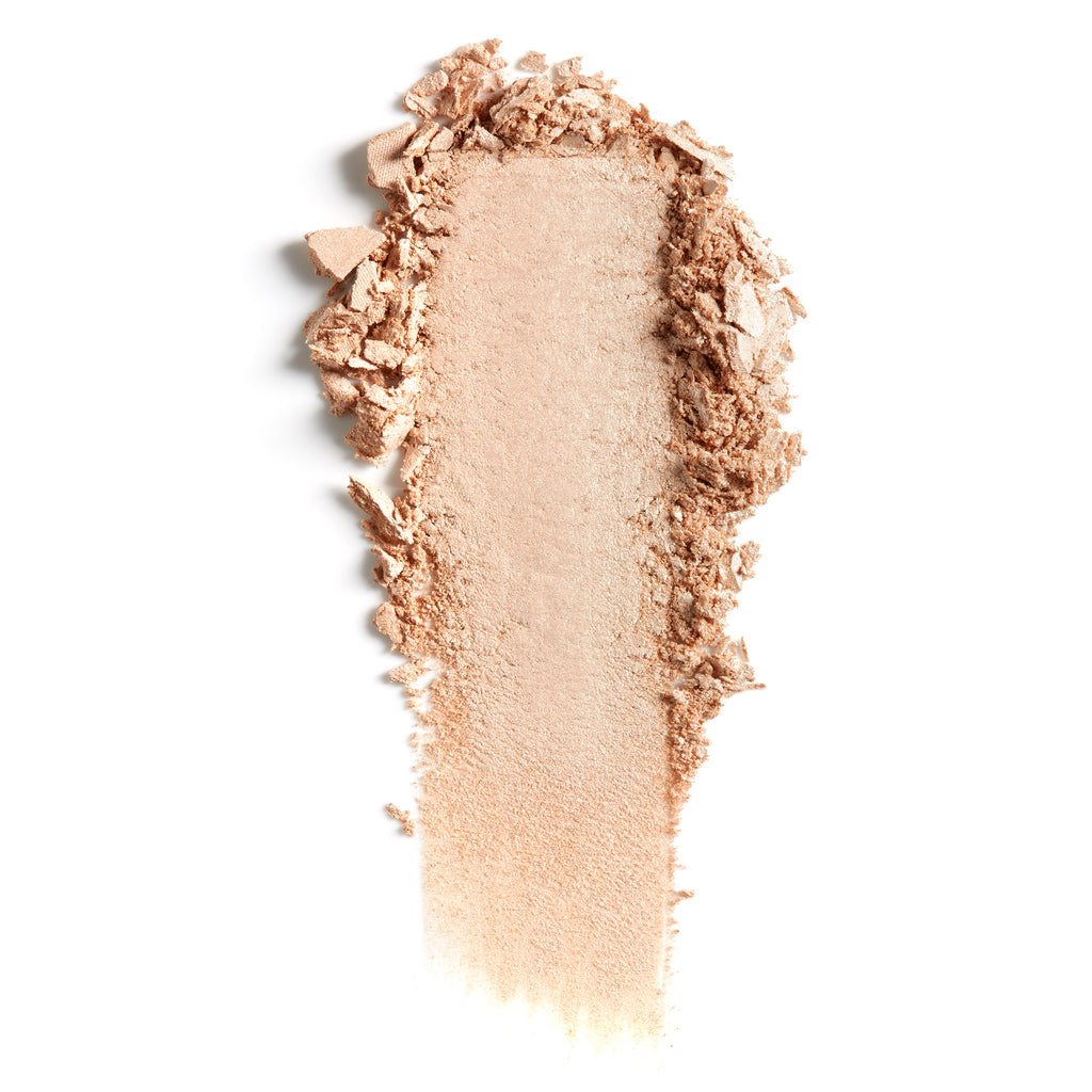 Smeared beige powder makeup on a white background.