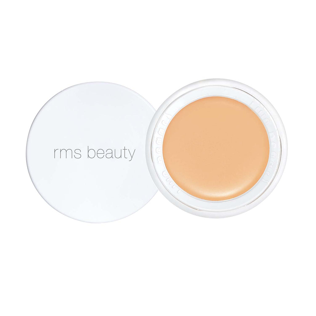 Open container of rms beauty brand concealer with a light beige tone.