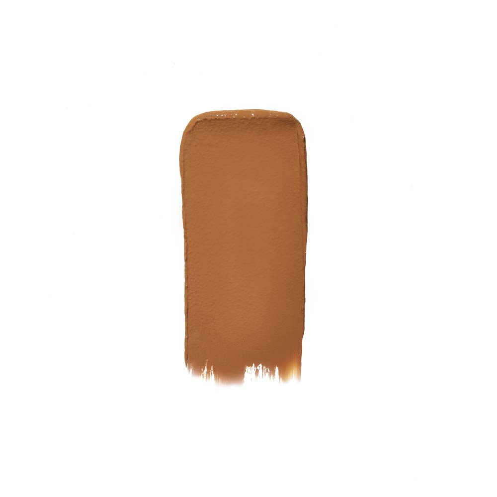 A swatch of brown liquid foundation makeup on a white background.
