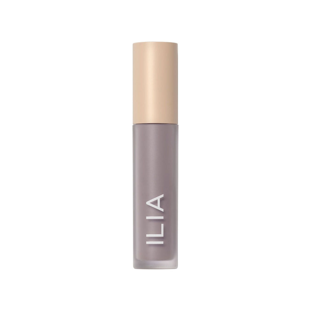 A bottle of ilia brand cosmetic product on a white background.
