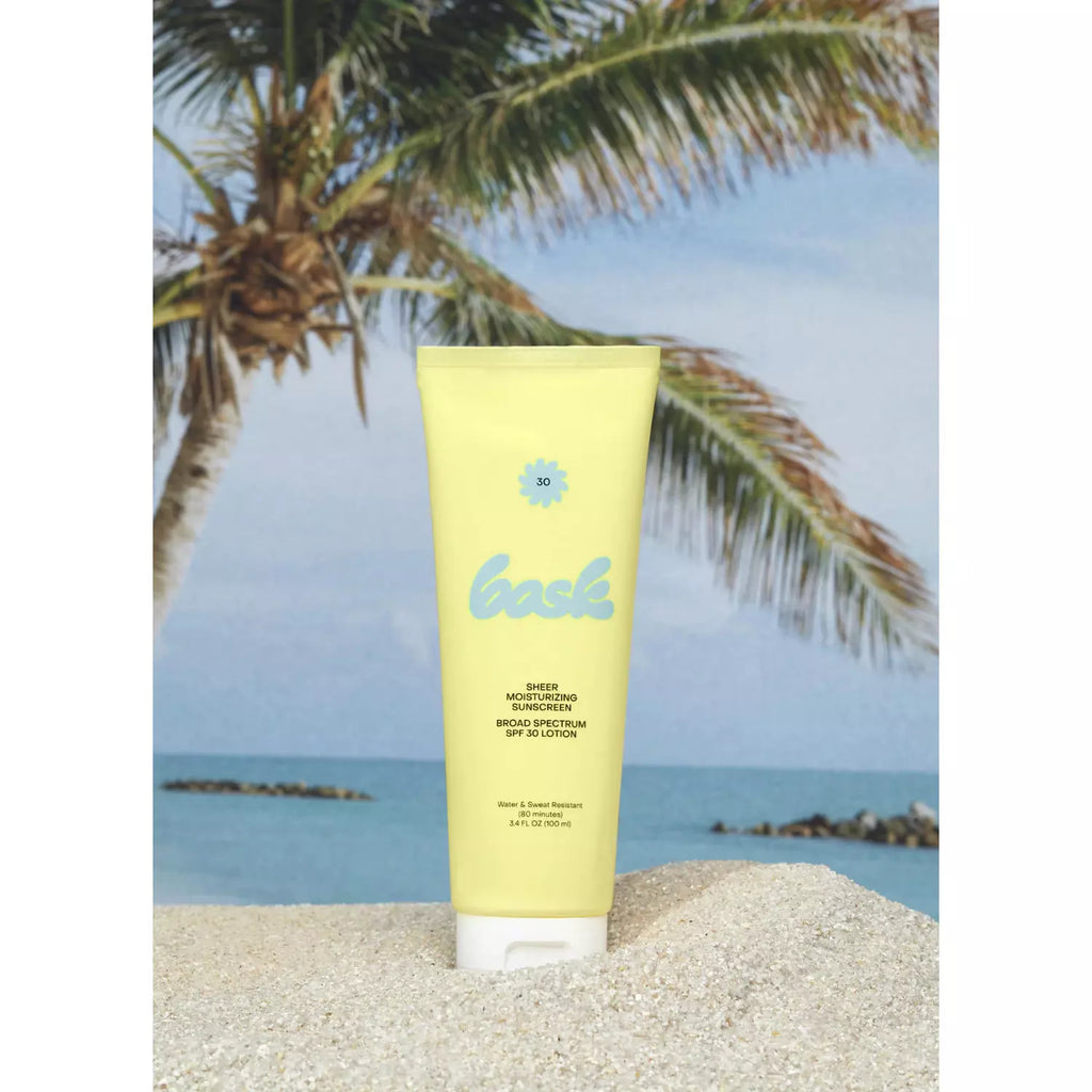 A tube of sunscreen with a tropical beach background.