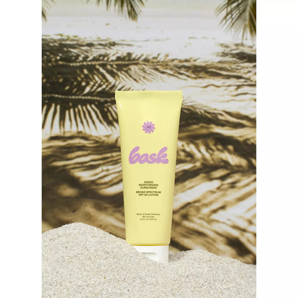 A tube of sunscreen lotion with a tropical beach backdrop.